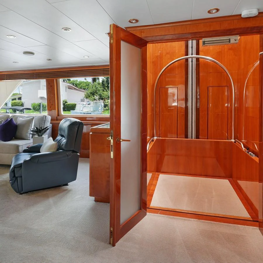 The yacht's interior features a cozy seating area and a polished wooden finish. aboard MILES AWEIGH Yacht for Sale