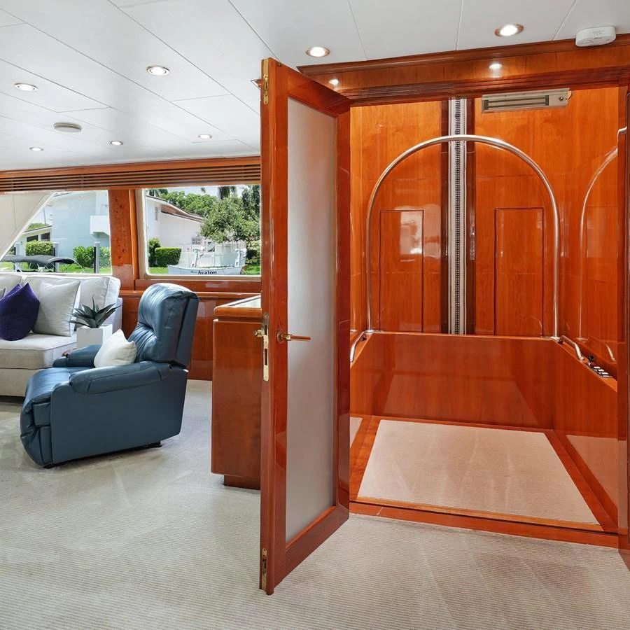 The yacht's interior features a cozy seating area with plush furnishings and a polished wooden finish. aboard MILES AWEIGH Yacht for Sale