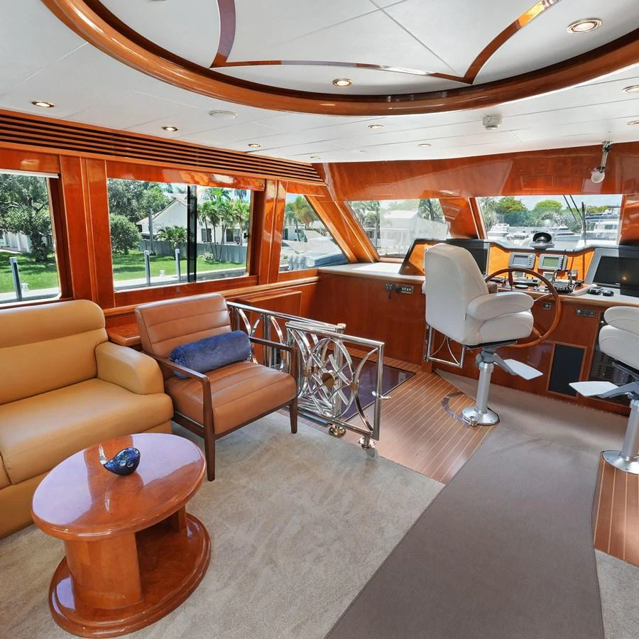 The salon offers a luxurious and comfortable space with plush seating and elegant wood finishes. aboard MILES AWEIGH Yacht for Sale