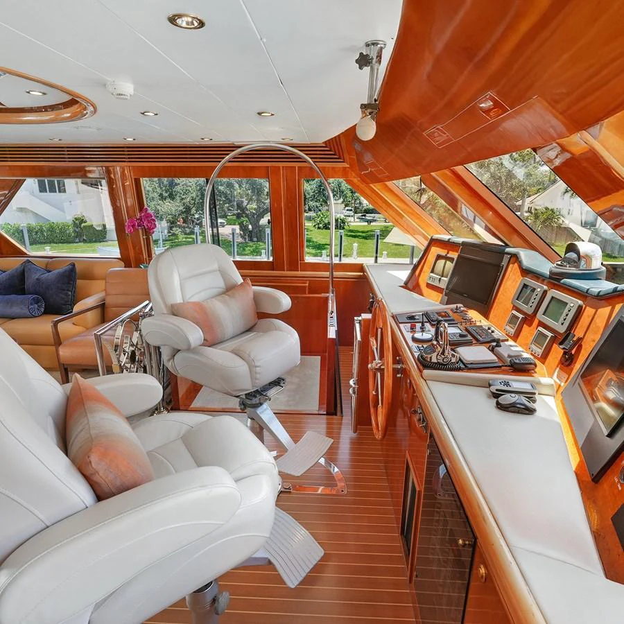 The helm area features luxurious seating and state-of-the-art navigation equipment, bathed in natural light. aboard MILES AWEIGH Yacht for Sale