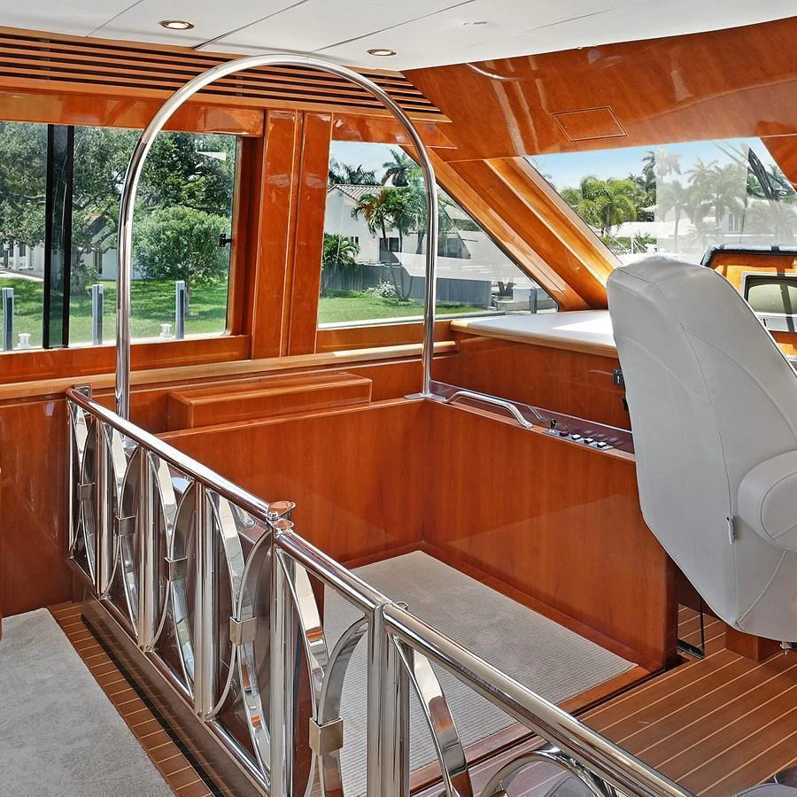 The yacht's helm features luxurious wooden finishes and a sleek, modern design. aboard MILES AWEIGH Yacht for Sale