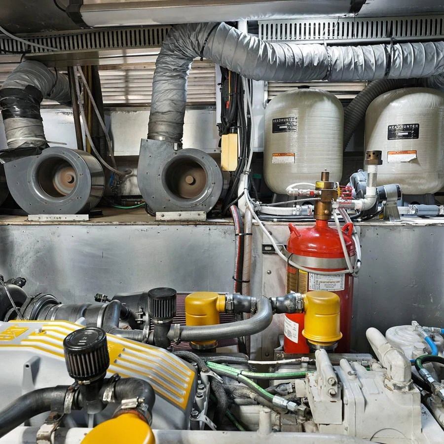 The image showcases the yacht's well-maintained engine room with various mechanical components and safety equipment. aboard MILES AWEIGH Yacht for Sale