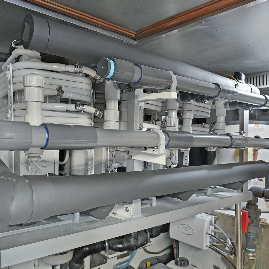 The image showcases the intricate plumbing and mechanical systems within the yacht. aboard MILES AWEIGH Yacht for Sale