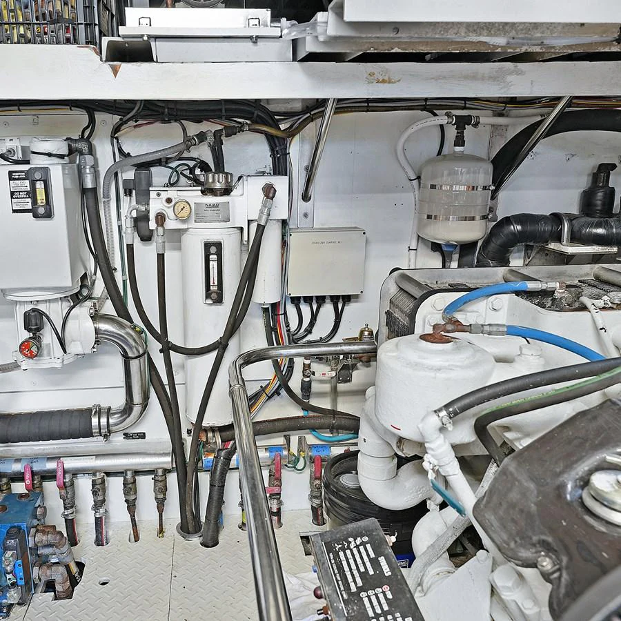 The image showcases the yacht's well-maintained engine room with various mechanical components and systems. aboard MILES AWEIGH Yacht for Sale