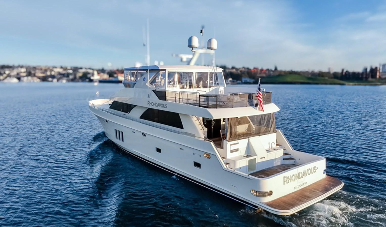 A sleek and modern yacht cruises gracefully on calm waters, showcasing its elegant design and spacious decks. aboard RHONDAVOUS Yacht for Sale