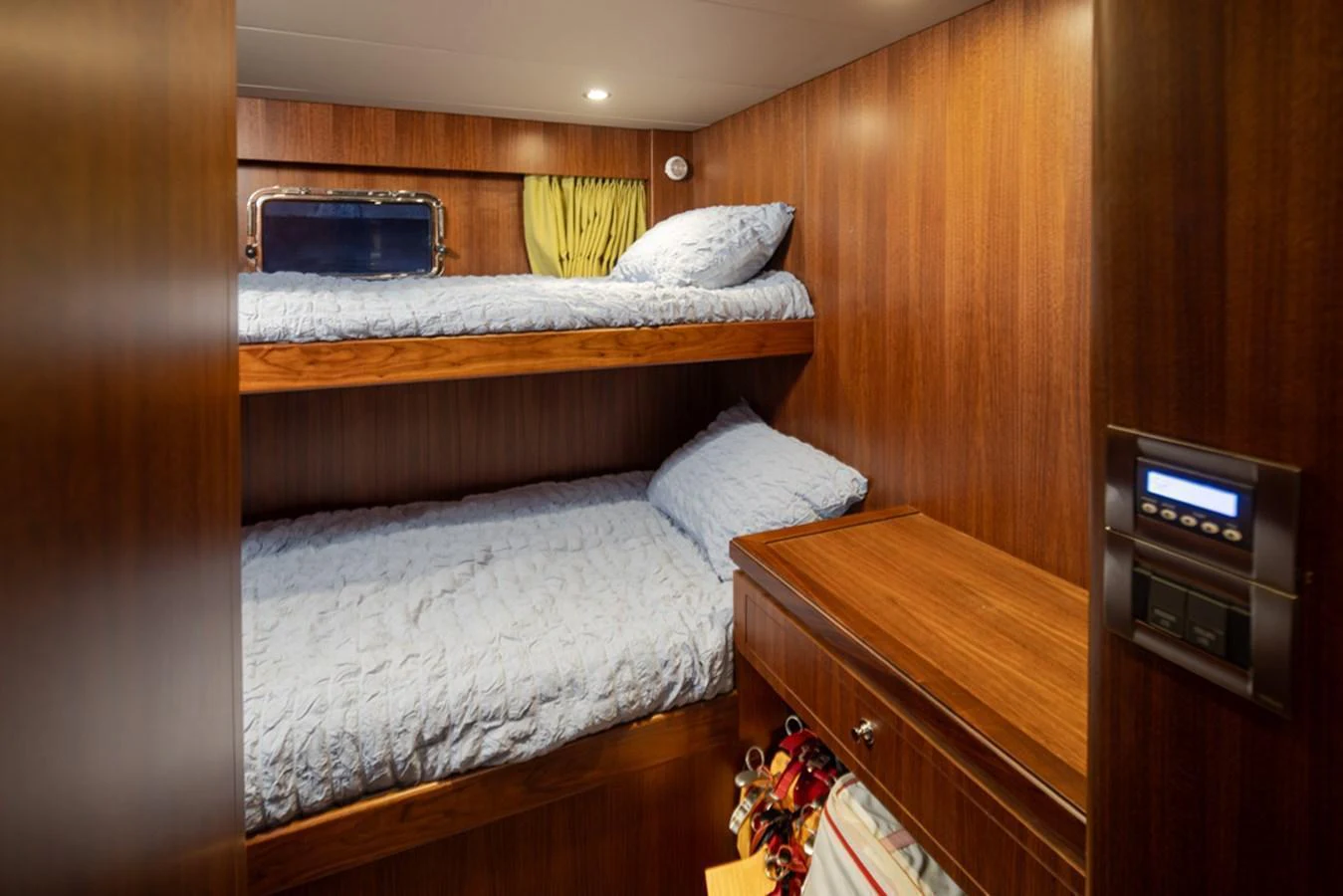 The cozy guest cabin features warm wood paneling and comfortable bunk beds. aboard RHONDAVOUS Yacht for Sale