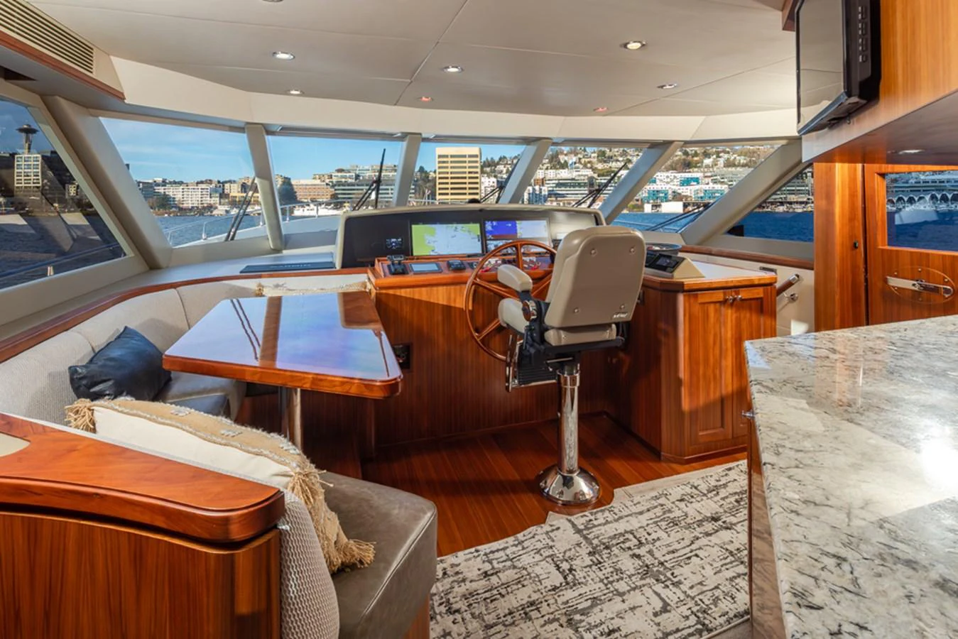The helm station offers a commanding view with luxurious wood finishes and state-of-the-art navigation equipment. aboard RHONDAVOUS Yacht for Sale