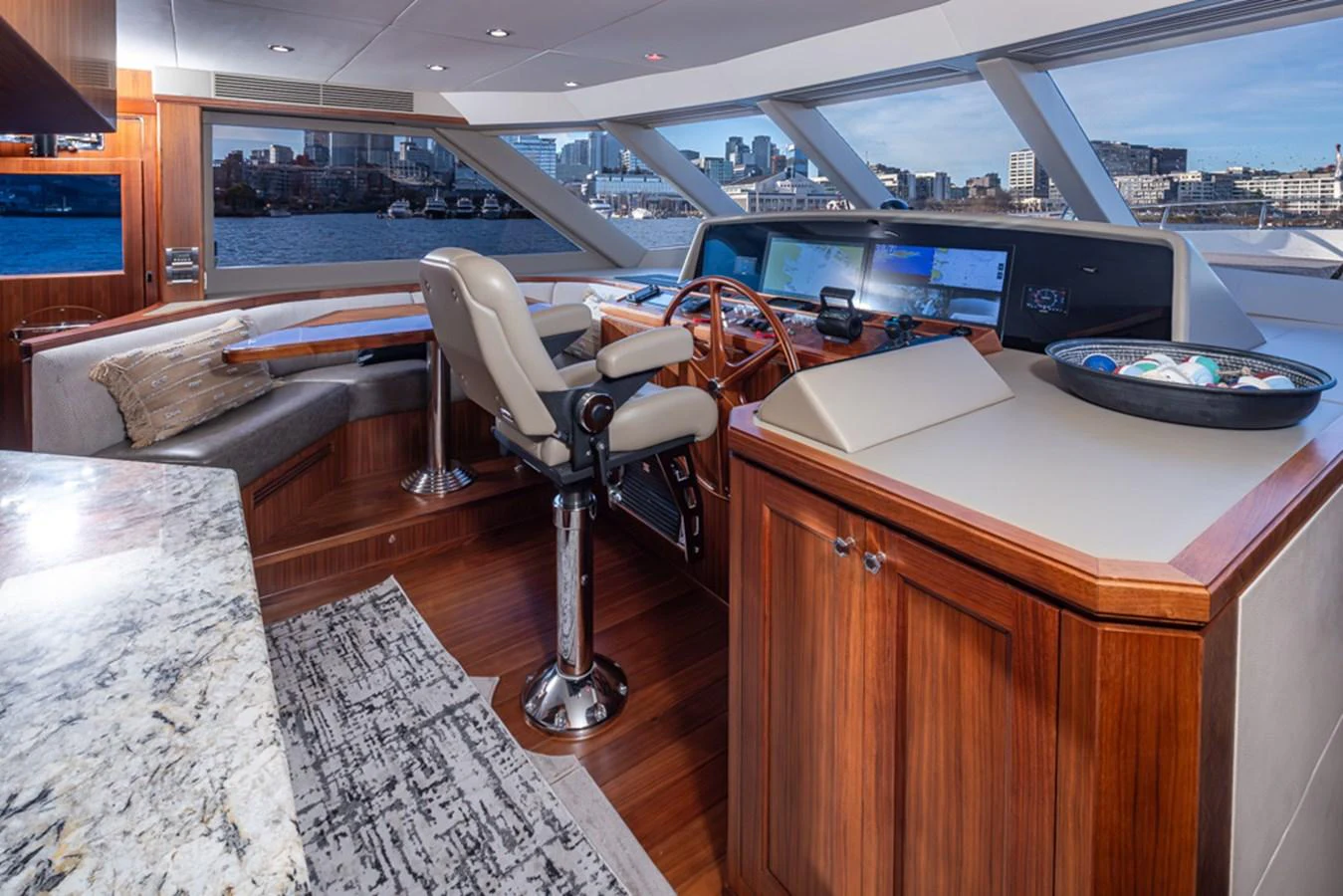 The helm station features luxurious seating and state-of-the-art navigation equipment with panoramic views. aboard RHONDAVOUS Yacht for Sale
