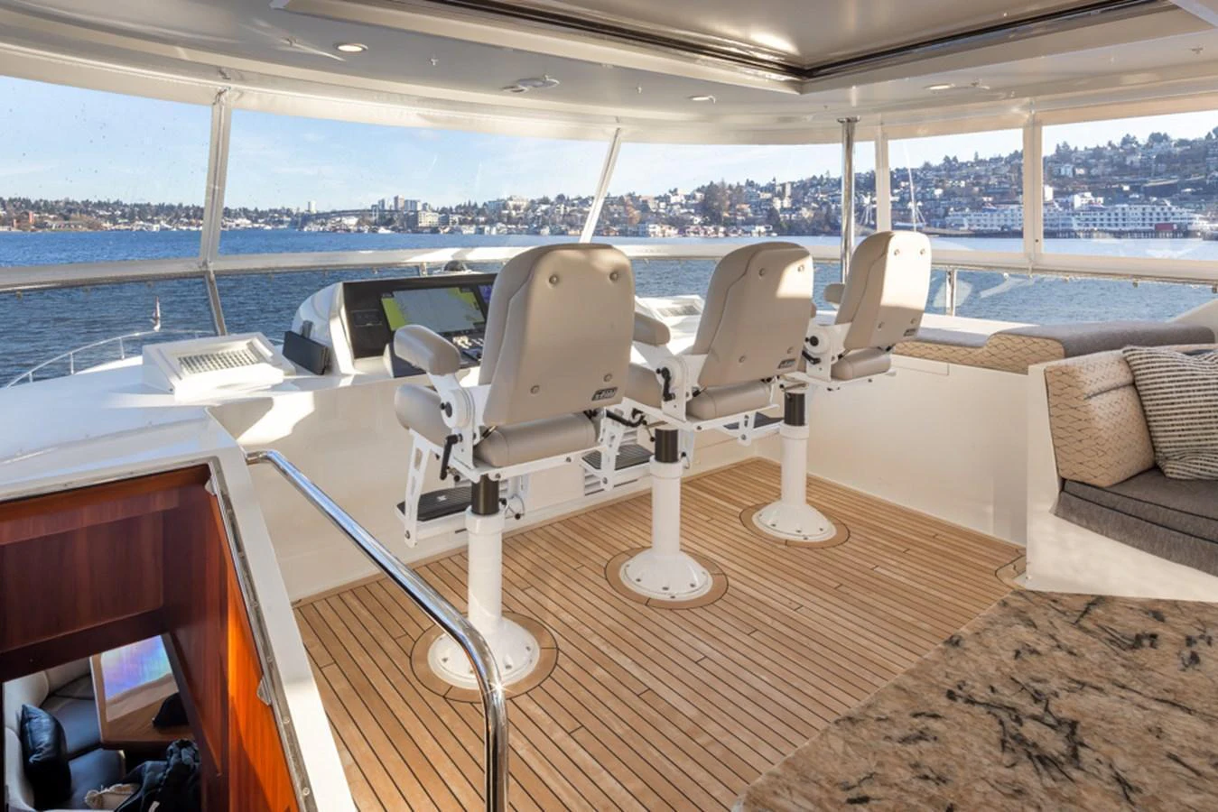 The helm area offers a commanding view with comfortable seating and a sleek design. aboard RHONDAVOUS Yacht for Sale