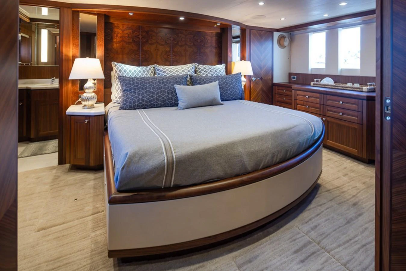 The master stateroom features a luxurious bed with elegant wood paneling and ample natural light. aboard RHONDAVOUS Yacht for Sale