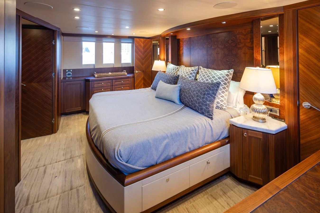 The master stateroom features a luxurious bed with elegant wooden finishes and soft lighting. aboard RHONDAVOUS Yacht for Sale