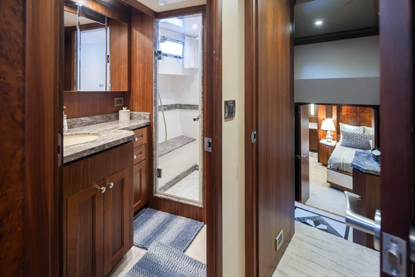 A luxurious hallway featuring rich wood paneling and a glimpse into a cozy bedroom. aboard RHONDAVOUS Yacht for Sale