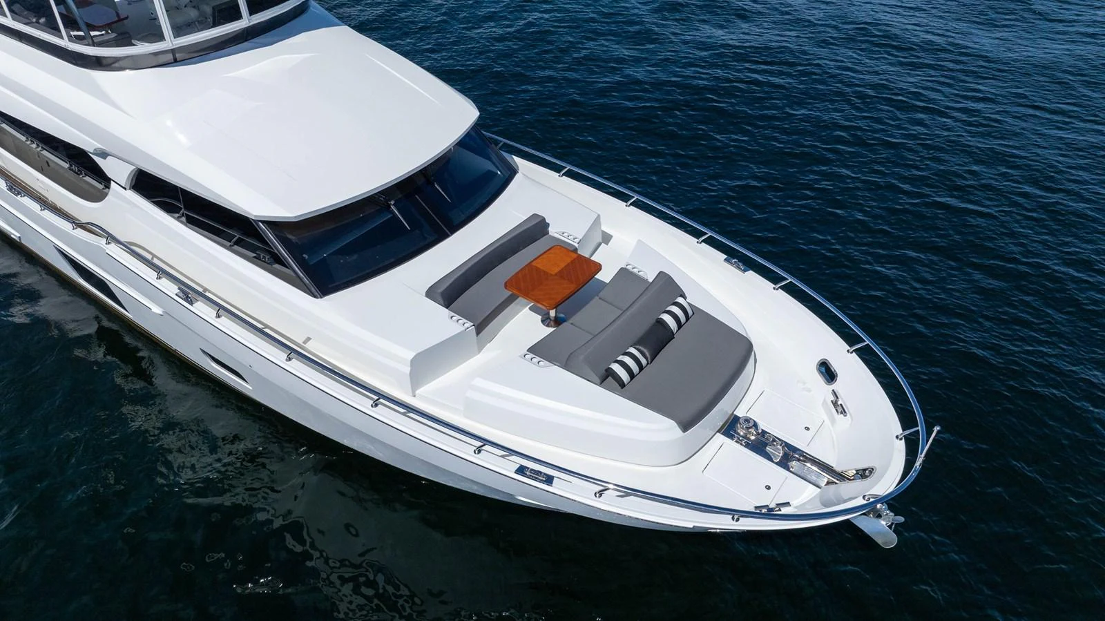 The foredeck of this yacht features a luxurious sunbathing area with plush cushions and a sleek design. aboard SUB-PAR Yacht for Sale