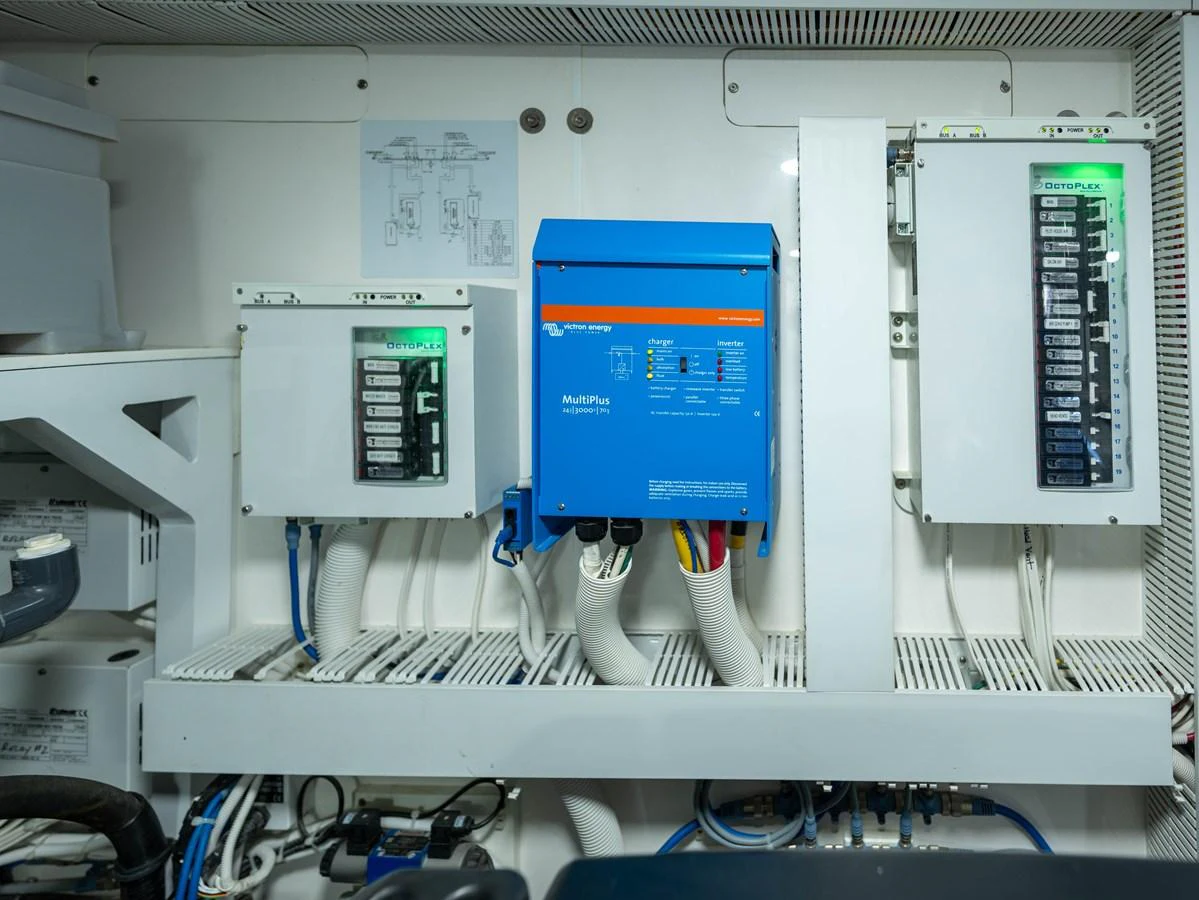 The image showcases the yacht's engine room with electrical panels and equipment. aboard SUB-PAR Yacht for Sale