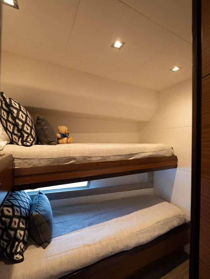 The cozy guest cabin features comfortable bunk beds and soft lighting, creating a welcoming atmosphere. aboard SUB-PAR Yacht for Sale