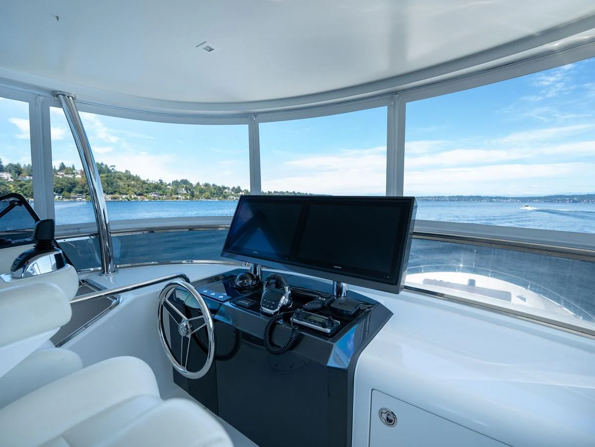 The helm station offers panoramic views and advanced navigation equipment. aboard SUB-PAR Yacht for Sale