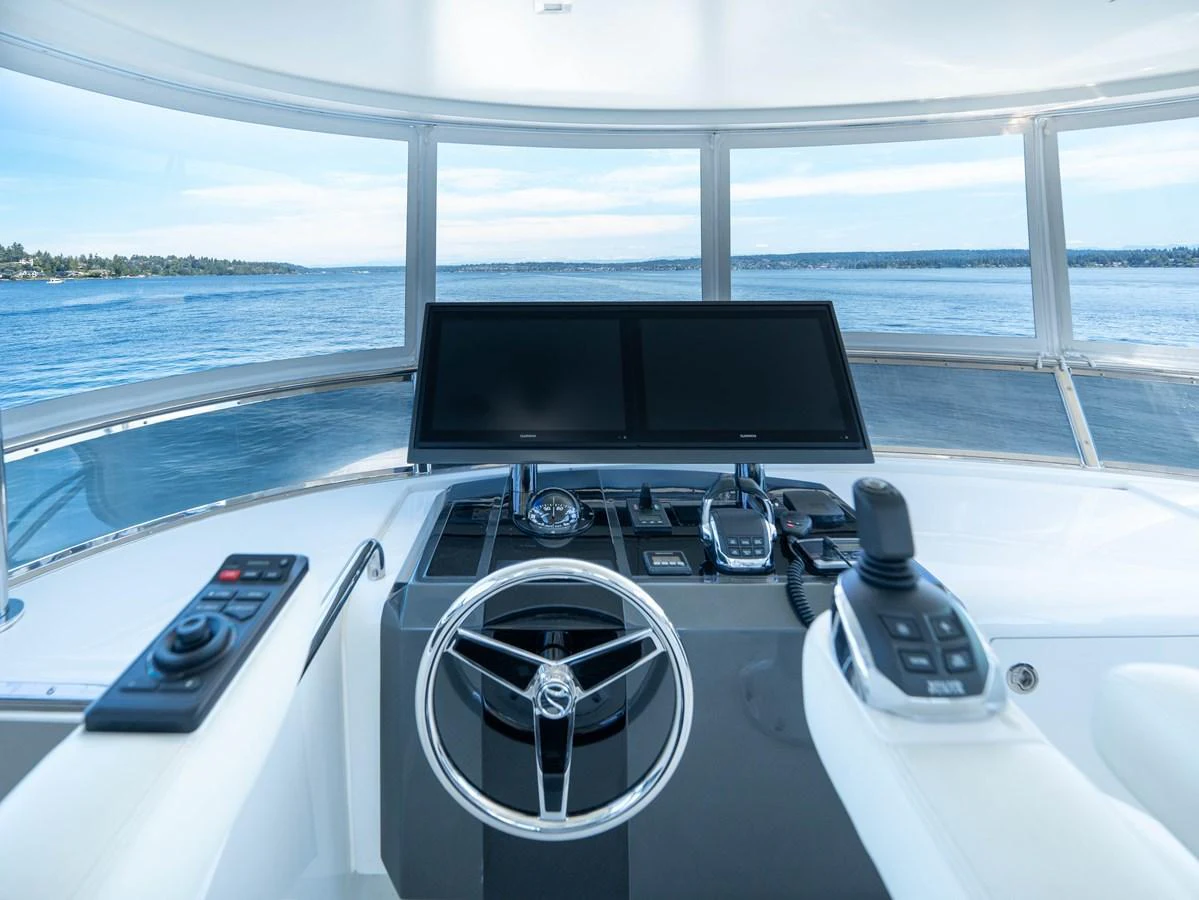 The helm station offers a panoramic view of the surrounding waters, equipped with advanced navigation technology. aboard SUB-PAR Yacht for Sale