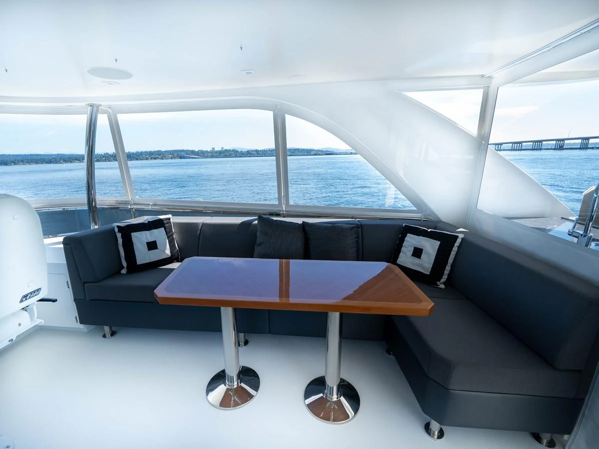 The salon features a comfortable seating area with panoramic views of the water. aboard SUB-PAR Yacht for Sale