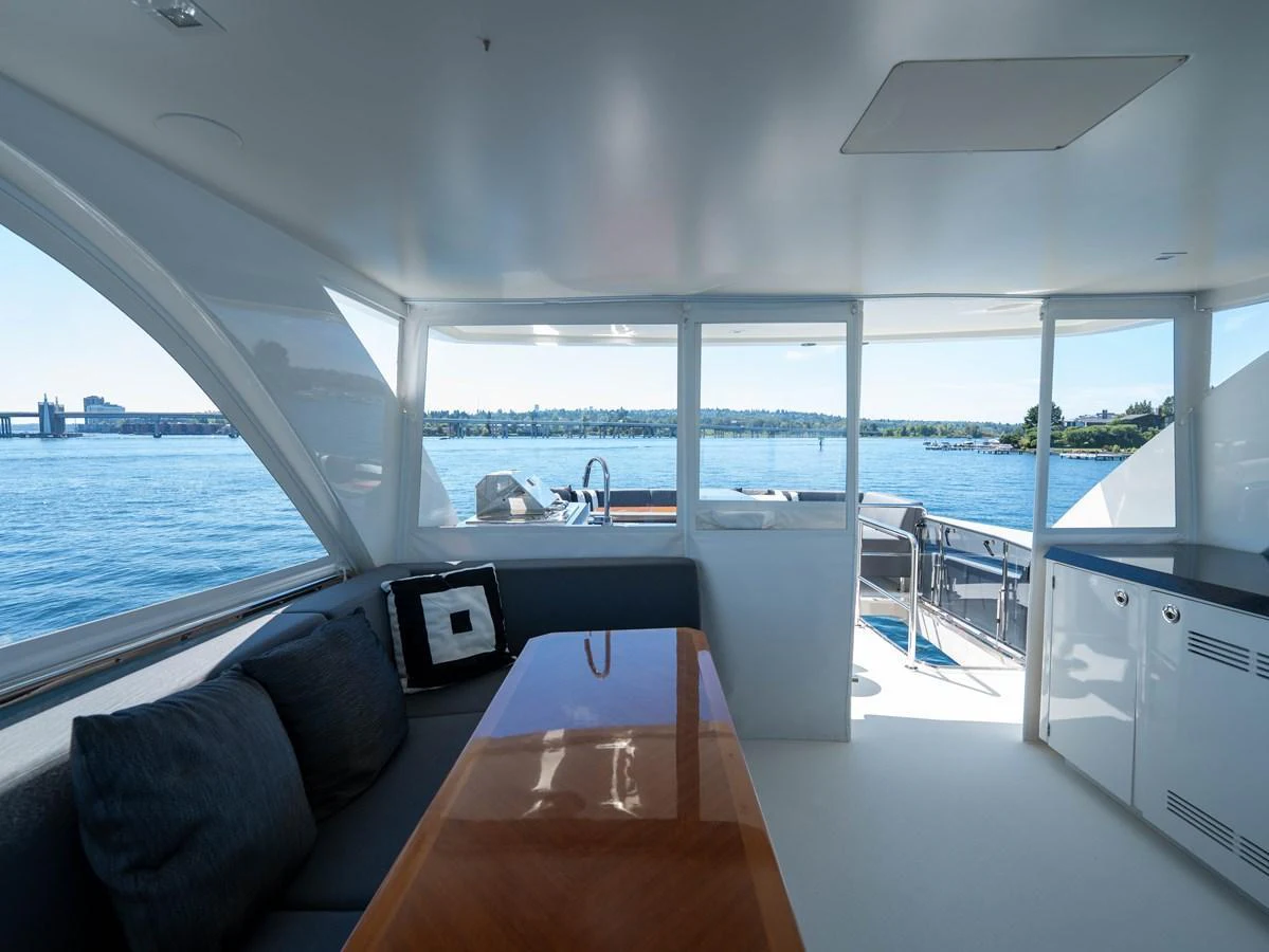 The yacht's salon offers a comfortable seating area with panoramic views of the water. aboard SUB-PAR Yacht for Sale