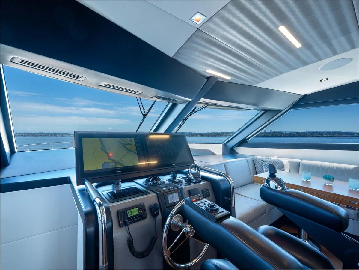 The helm station offers a sleek and modern command center with expansive views. aboard SUB-PAR Yacht for Sale
