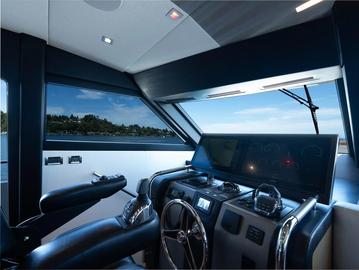 The helm station features advanced navigation equipment and a sleek, modern design. aboard SUB-PAR Yacht for Sale