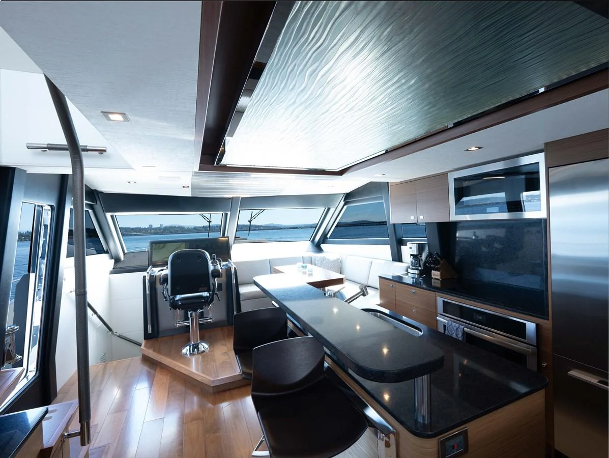 The yacht's helm area features modern furnishings and expansive windows offering stunning views. aboard SUB-PAR Yacht for Sale