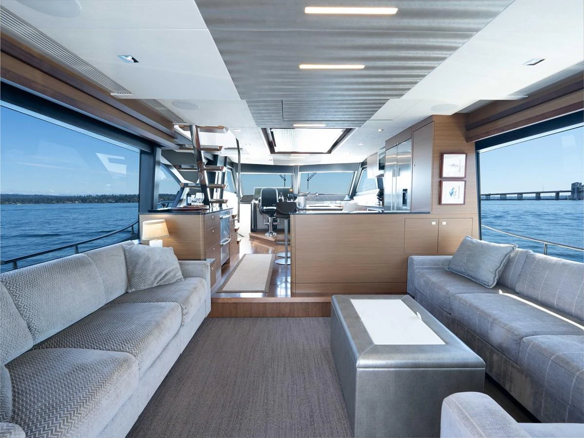 The salon offers a spacious and luxurious seating area with panoramic views of the water. aboard SUB-PAR Yacht for Sale