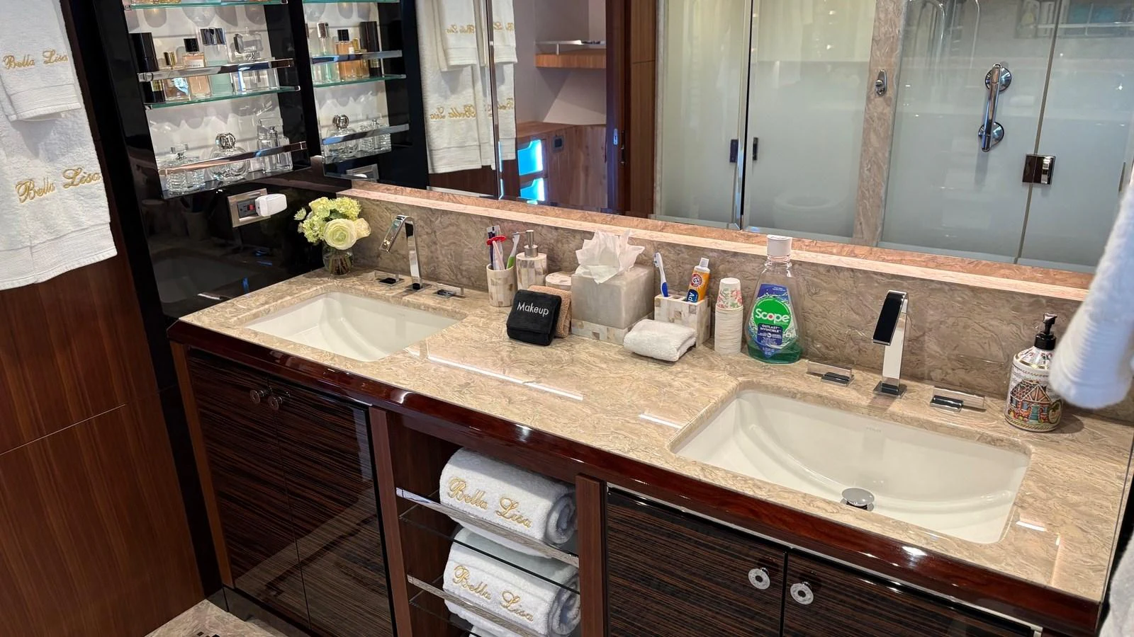 The yacht's bathroom features a luxurious double sink vanity with elegant fixtures and ample storage. aboard BELLA LISA Yacht for Sale
