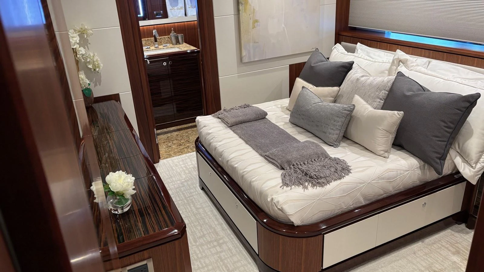 A luxurious stateroom featuring a plush bed with elegant linens and a stylish ensuite bathroom. aboard BELLA LISA Yacht for Sale