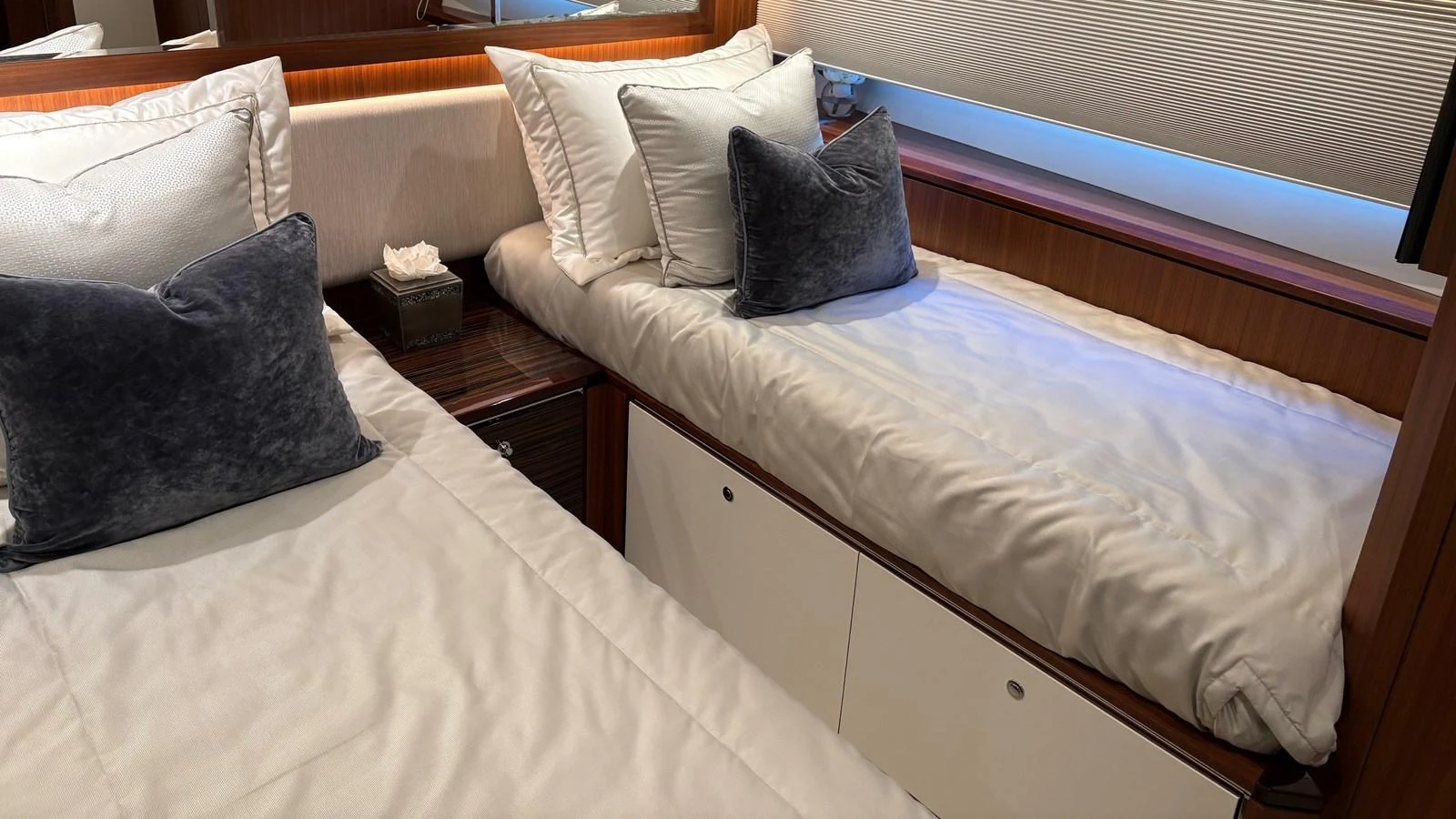 The guest stateroom features twin beds with plush pillows and elegant wood finishes. aboard BELLA LISA Yacht for Sale