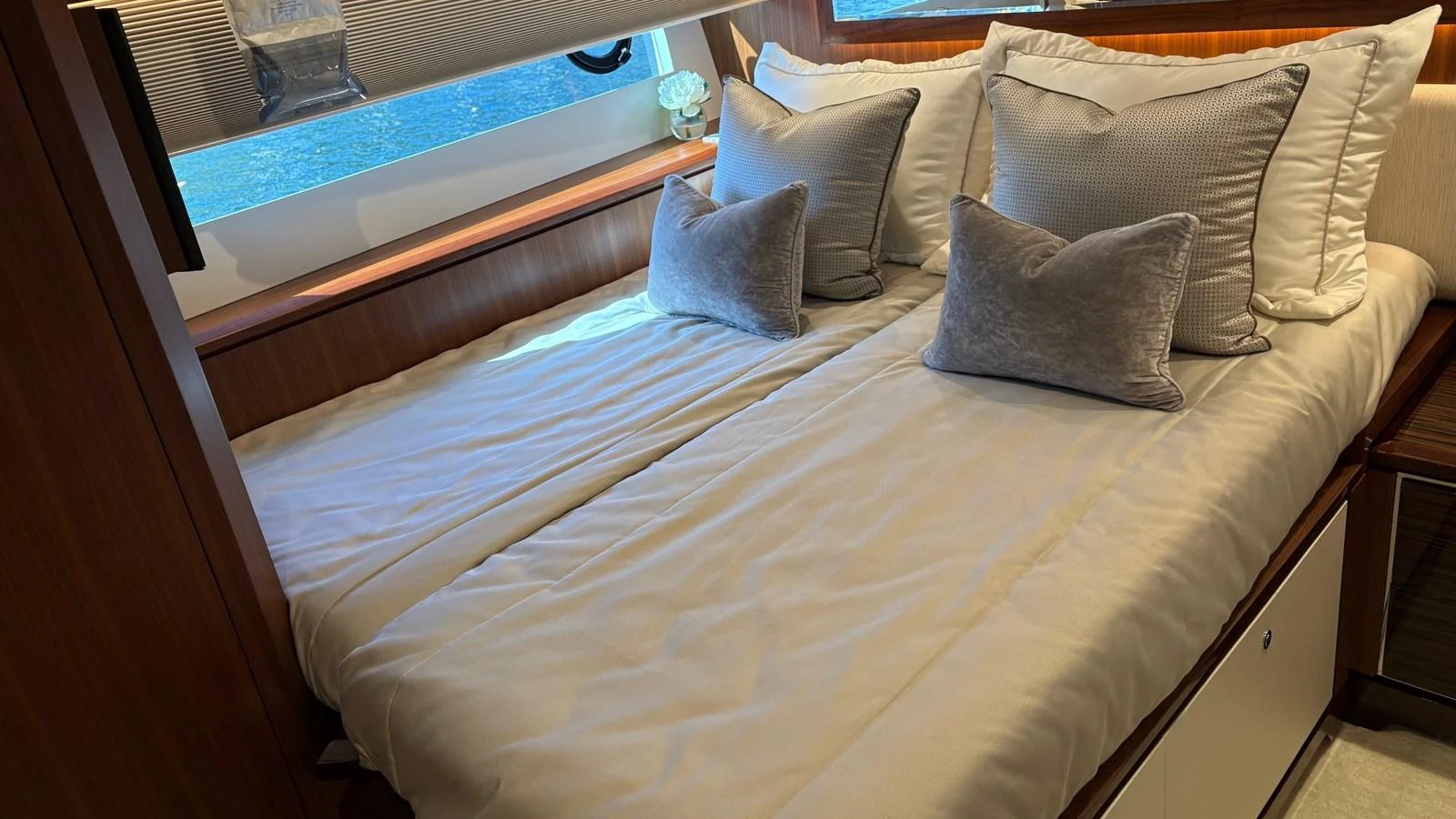 The guest stateroom features a cozy double bed with plush pillows and elegant wood finishes. aboard BELLA LISA Yacht for Sale