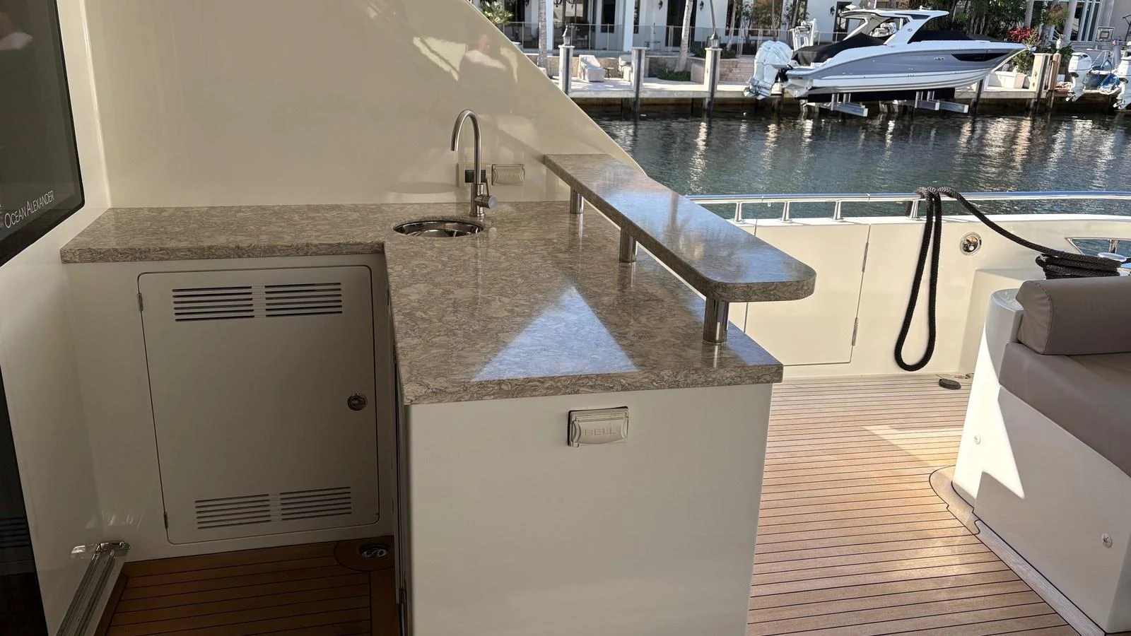 The aft deck features a sleek wet bar with a polished countertop and a comfortable seating area, perfect for entertaining. aboard BELLA LISA Yacht for Sale