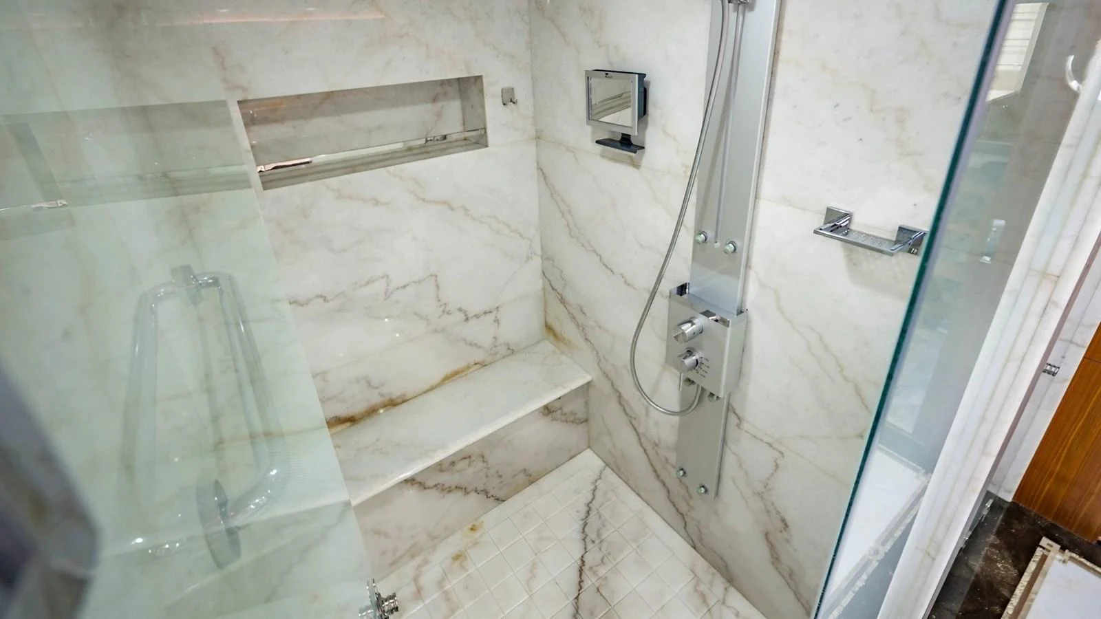 The yacht's bathroom features luxurious marble walls and modern fixtures. aboard BELLA LISA Yacht for Sale