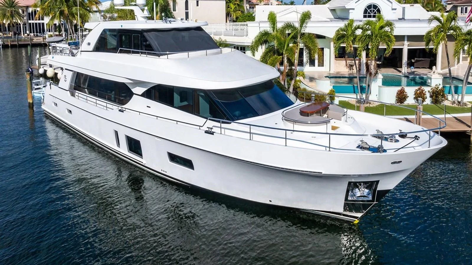 A sleek and modern yacht is docked in a serene marina, showcasing its elegant lines and spacious deck areas. aboard BELLA LISA Yacht for Sale