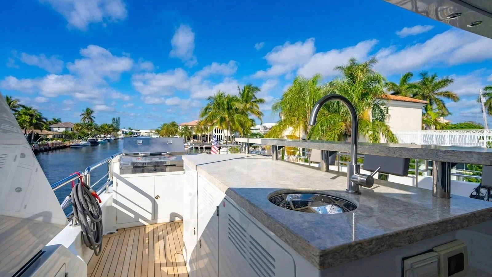 The aft deck features a sleek outdoor kitchen area with a sink and ample counter space, perfect for alfresco dining. aboard BELLA LISA Yacht for Sale