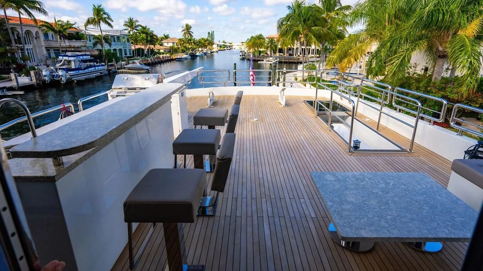 The sundeck offers a spacious area with bar seating and a beautiful view of the surrounding waterway. aboard BELLA LISA Yacht for Sale