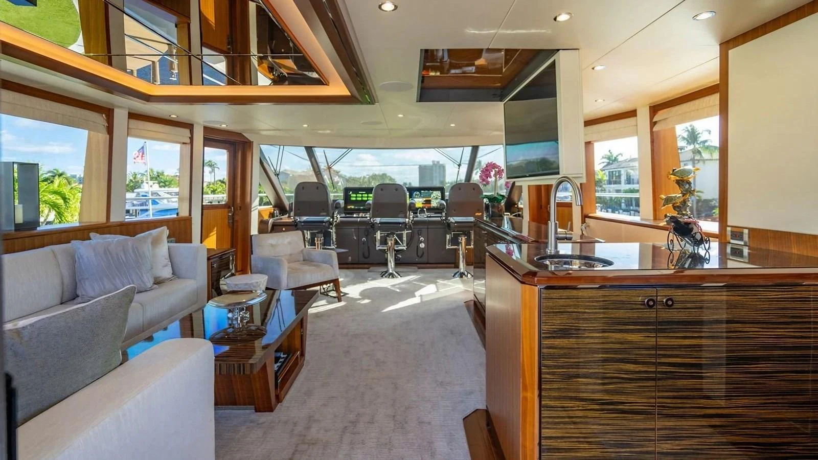 The salon features luxurious seating, a modern entertainment area, and panoramic windows offering stunning views. aboard BELLA LISA Yacht for Sale