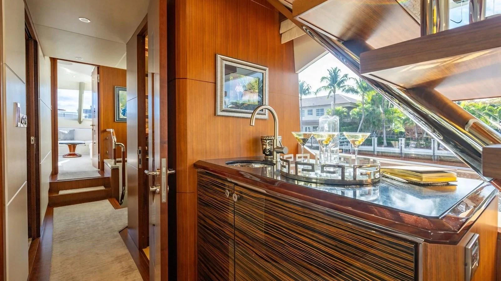 A luxurious galley area with a sleek wooden finish and a well-stocked bar. aboard BELLA LISA Yacht for Sale