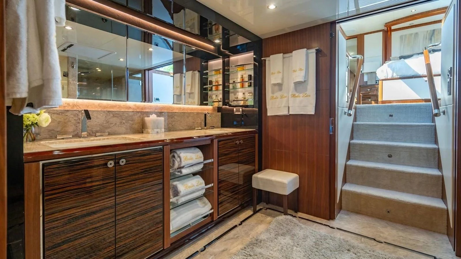 This luxurious bathroom features elegant wood finishes and modern amenities. aboard BELLA LISA Yacht for Sale