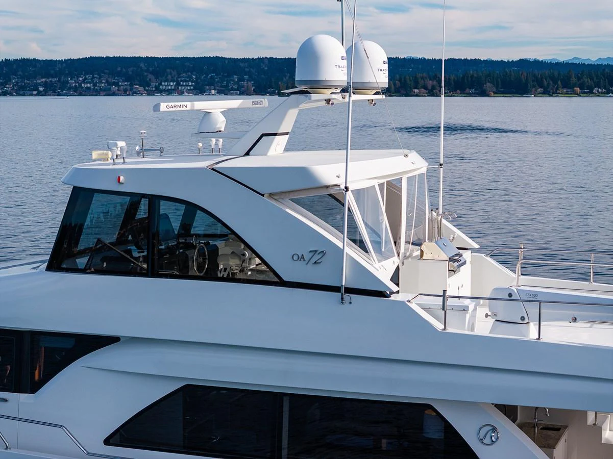 The yacht is shown on calm waters with a clear view of its upper deck and radar equipment. aboard ISLAND BREEZE Yacht for Sale