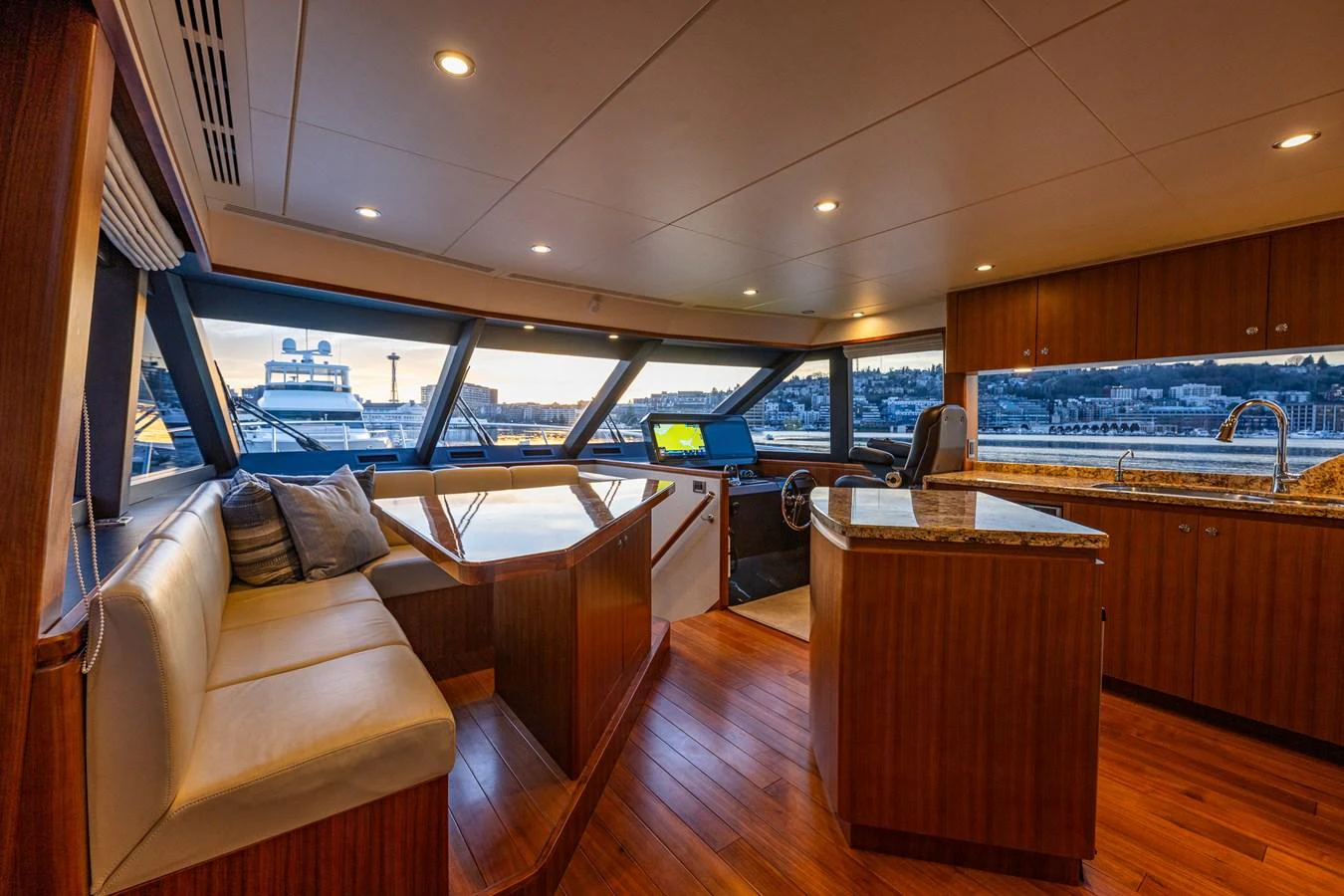 The helm area features a comfortable seating arrangement and modern navigation equipment. aboard ISLAND BREEZE Yacht for Sale