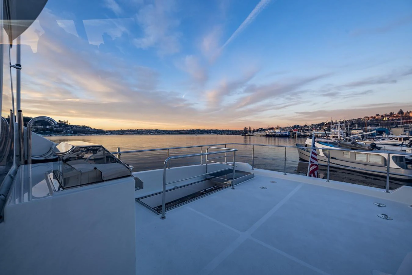The yacht's aft deck offers a serene view of the harbor at sunset. aboard ISLAND BREEZE Yacht for Sale