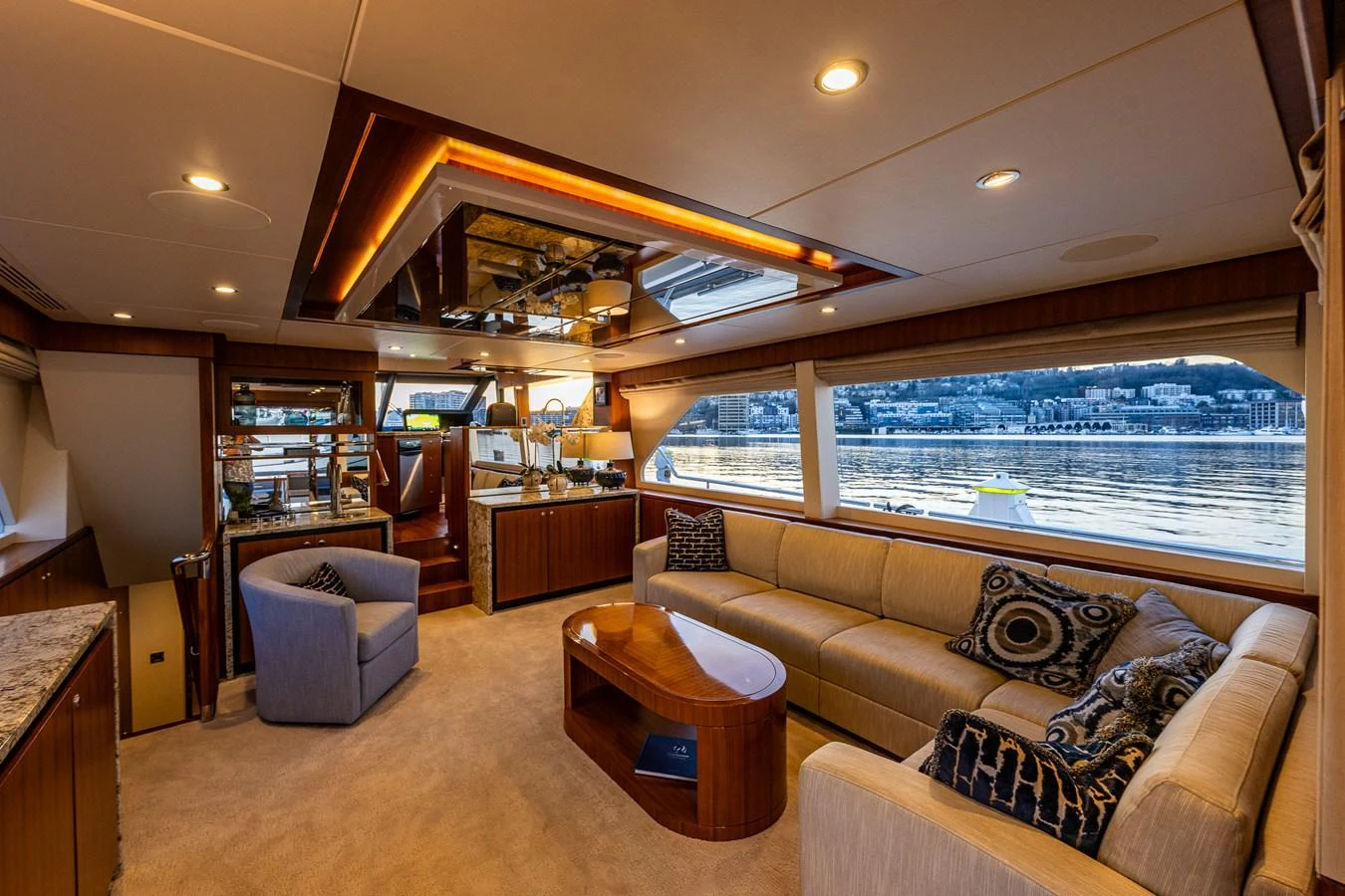 The yacht's salon features comfortable seating, elegant lighting, and large windows offering scenic views. aboard ISLAND BREEZE Yacht for Sale