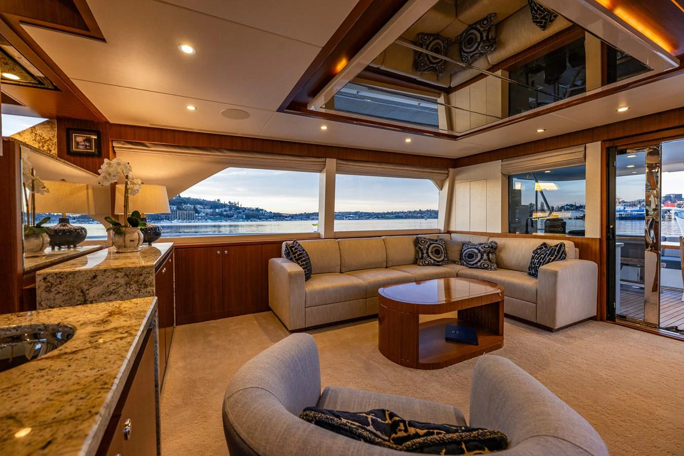 The yacht's salon features a spacious seating area with elegant decor and large windows offering scenic views. aboard ISLAND BREEZE Yacht for Sale