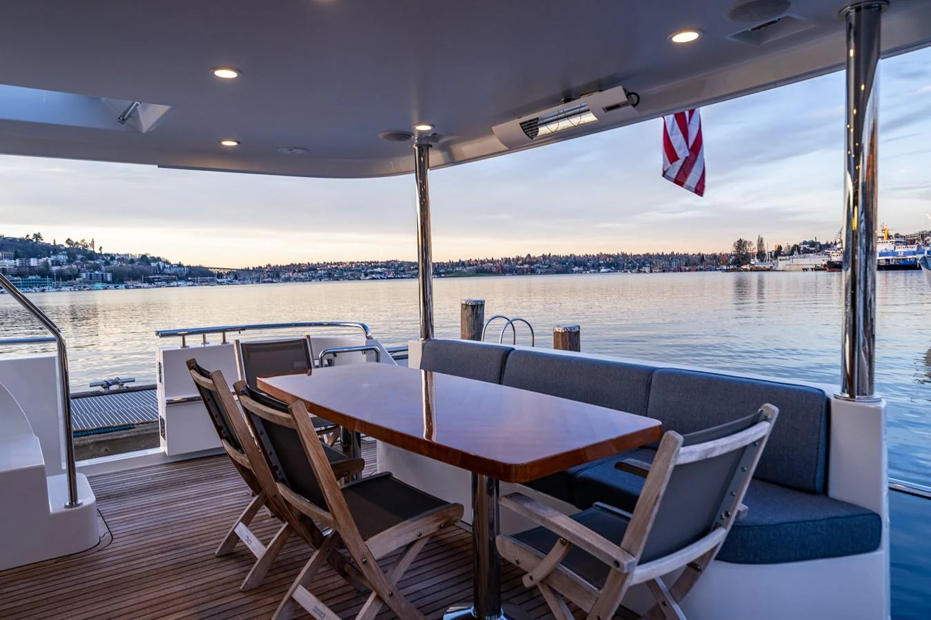 The aft deck features a comfortable seating area with a table, perfect for enjoying the scenic views. aboard ISLAND BREEZE Yacht for Sale