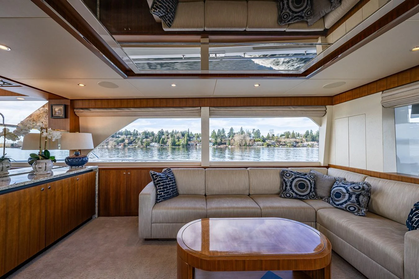 The salon features a spacious seating area with large windows offering panoramic views. aboard ISLAND BREEZE Yacht for Sale
