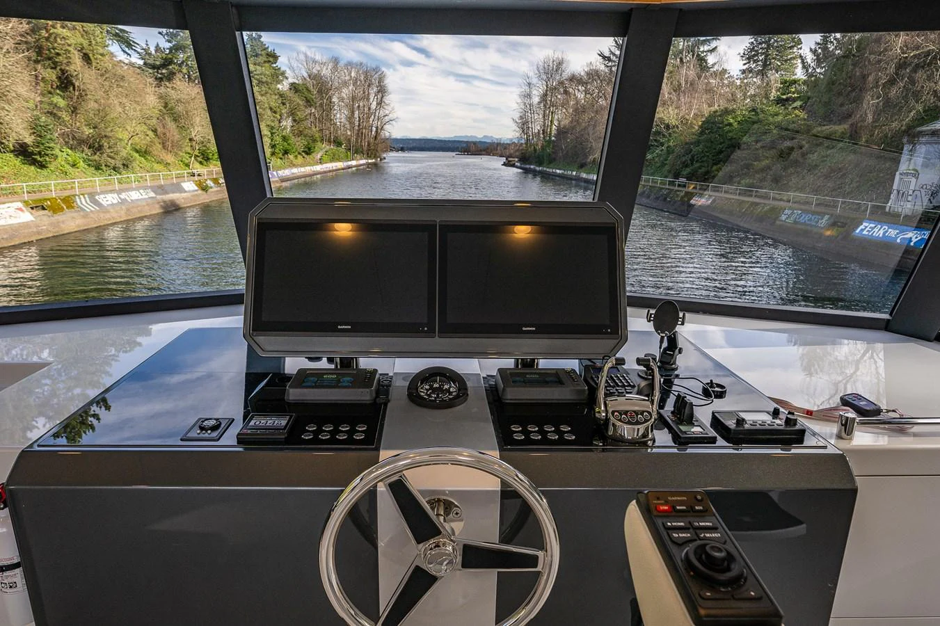 The helm station offers a commanding view of the waterway ahead, equipped with advanced navigation systems. aboard ISLAND BREEZE Yacht for Sale