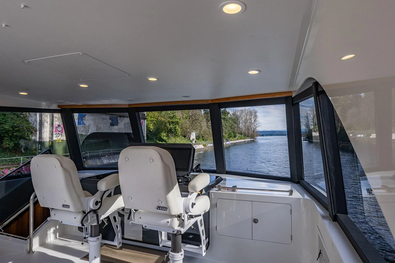 The helm station offers panoramic views with modern seating and advanced navigation equipment. aboard ISLAND BREEZE Yacht for Sale