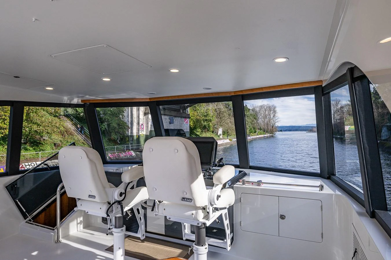 The helm station offers panoramic views and modern seating for optimal navigation. aboard ISLAND BREEZE Yacht for Sale