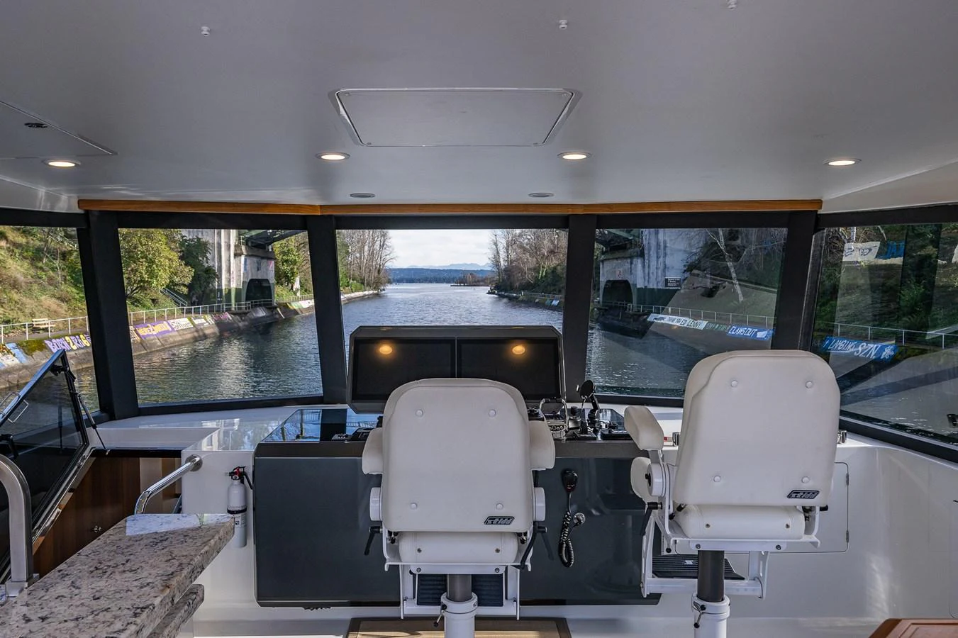 The helm offers a commanding view of the waterway ahead, framed by large windows. aboard ISLAND BREEZE Yacht for Sale